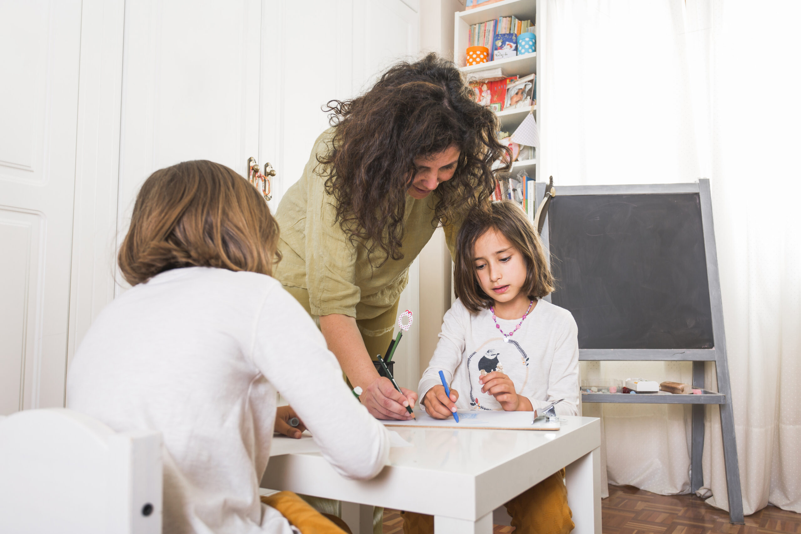 mother helping daughters with drawings scaled GAPP Program